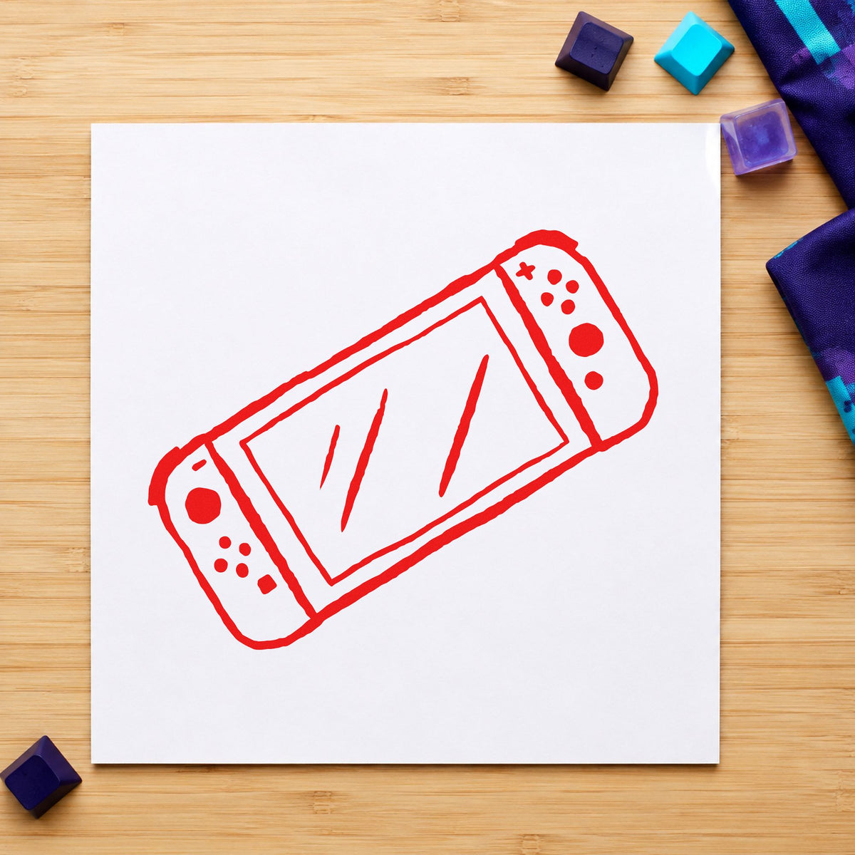 Handheld Gaming Console Outline craft stamp imprint in red ink on a handmade project, one idea being travel game cards.