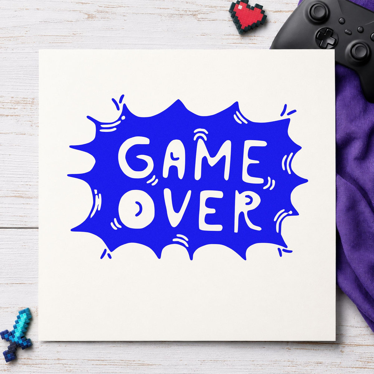 Game Over Comic Burst craft stamp in blue ink on cardstock, an easy option for table skirt printing.
