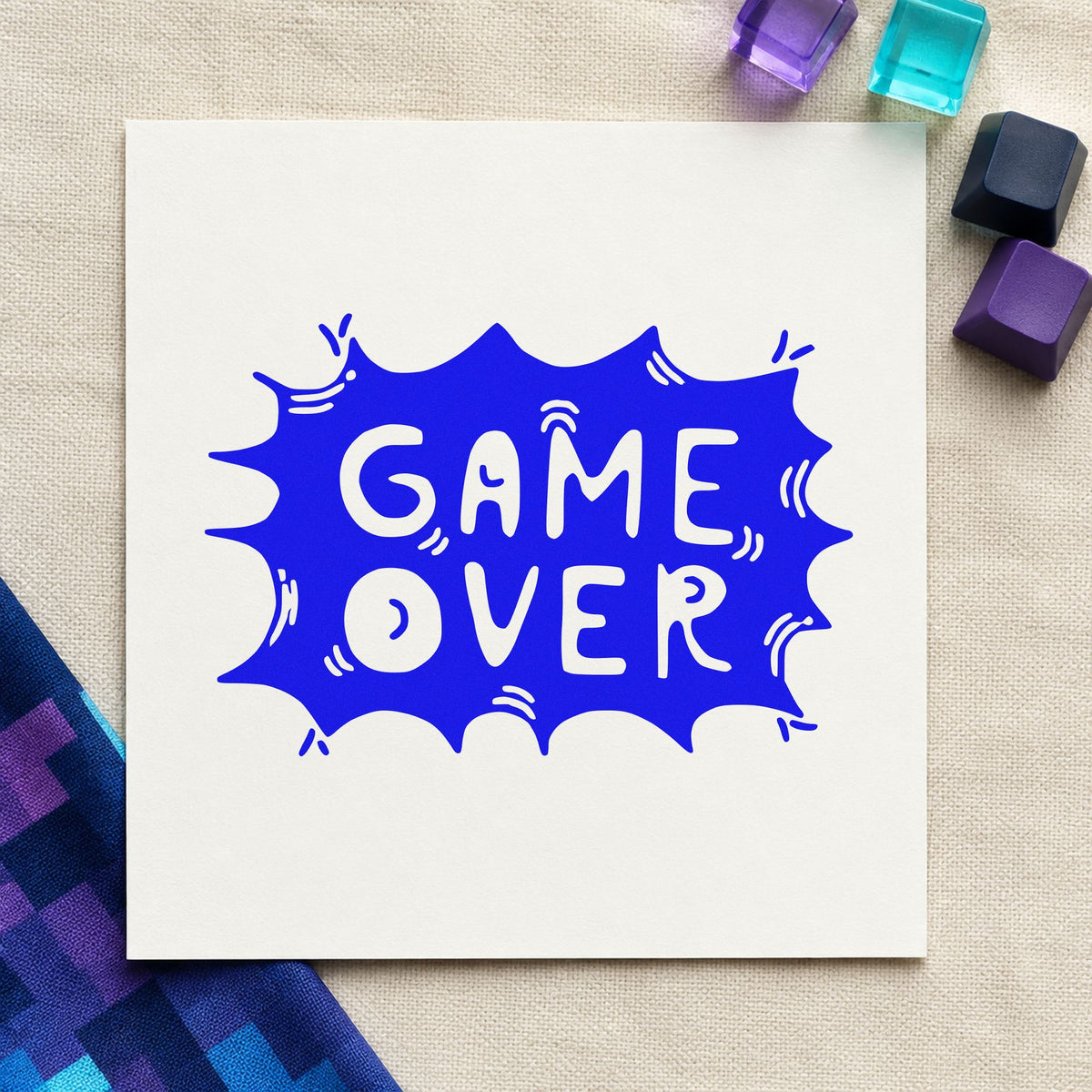 Game Over Comic Burst craft stamp imprinted in blue ink on paper, a design suited to framed party entry.