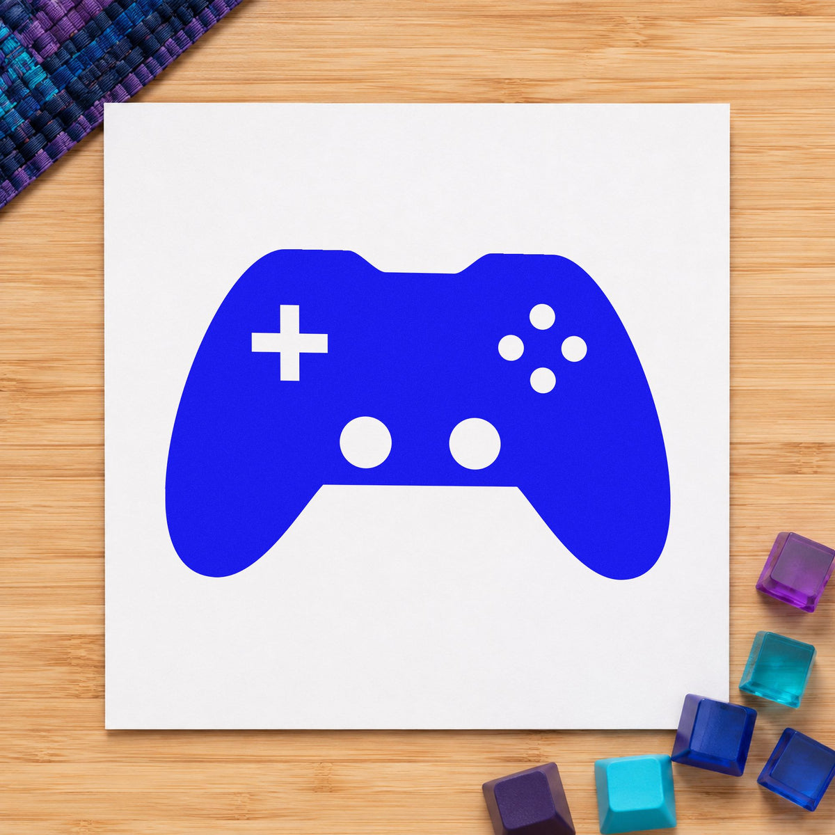 Solid Dual Stick Controller craft stamp imprinted in blue ink on paper, a design suited to framed venue foyer.