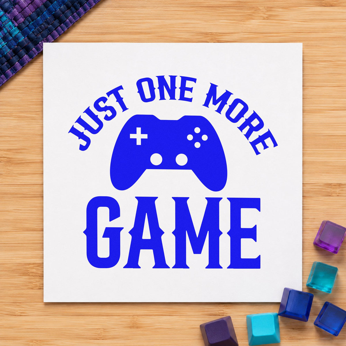 Just One More Game craft stamp in blue ink on cardstock, an easy option for cushion cover printing.
