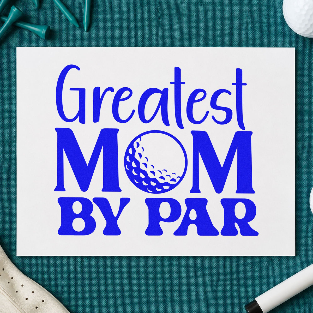 Greatest Mom By Par craft stamp imprinted in blue ink on paper, a design suited to framed kitchen shelf.