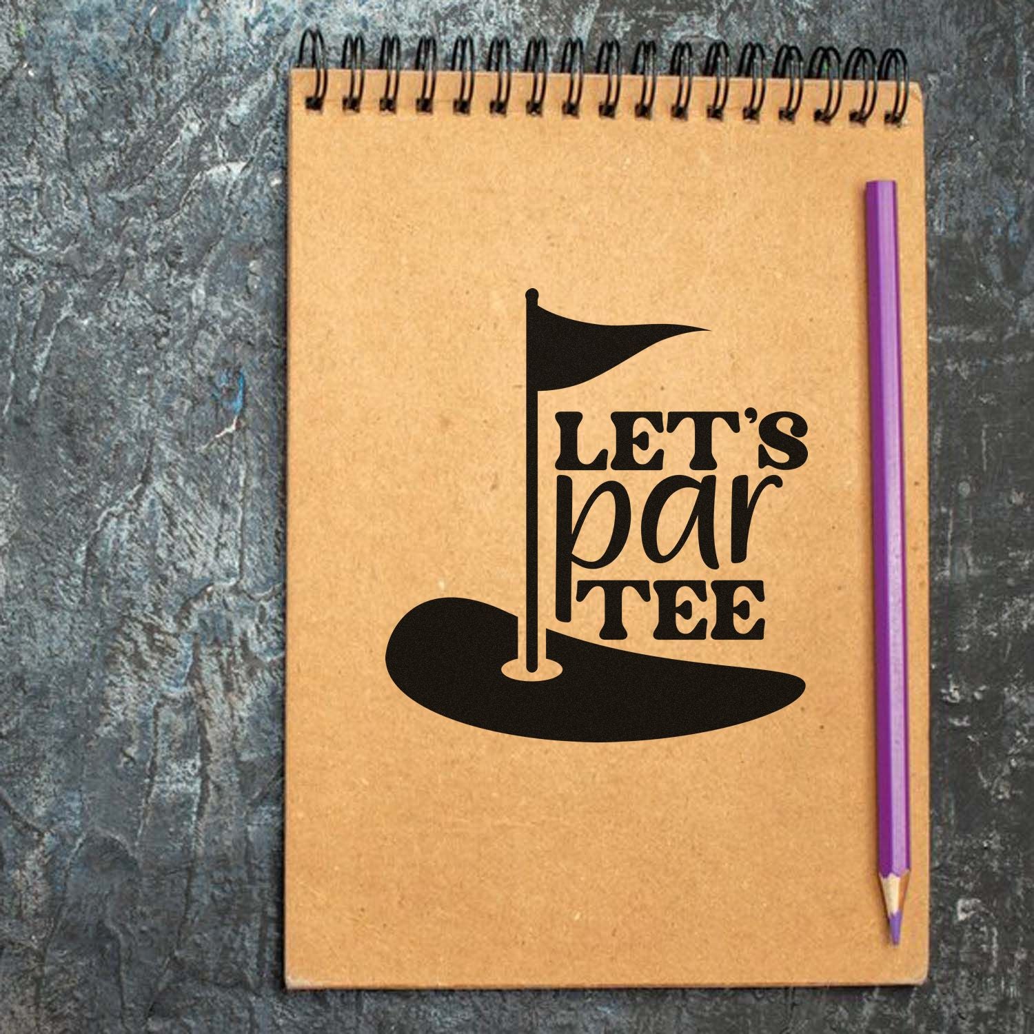 Golf-themed rubber stamp design with Lets Par Tee pun, flag and putting green on a notebook mockup.
