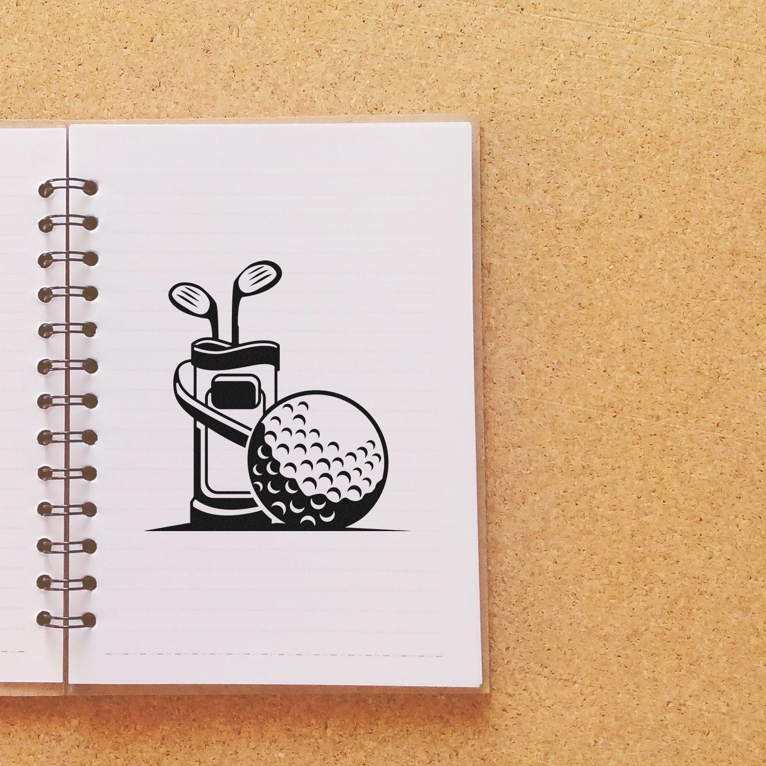 Golf bag and ball rubber stamp design on a notebook page, ideal for golf-themed crafts, stationery, and custom stamping.