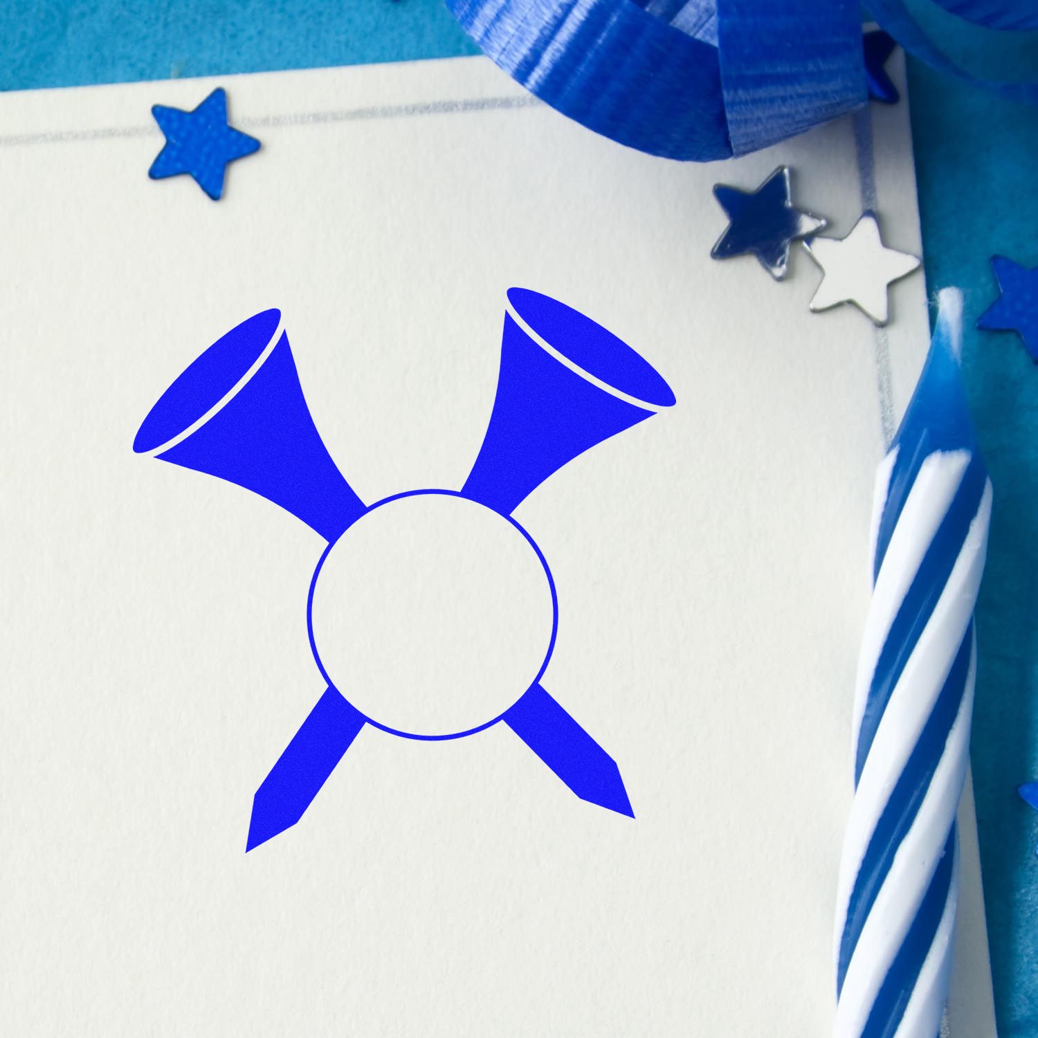 Blue festive rubber stamp impression with party horns and star accents on white cardstock.