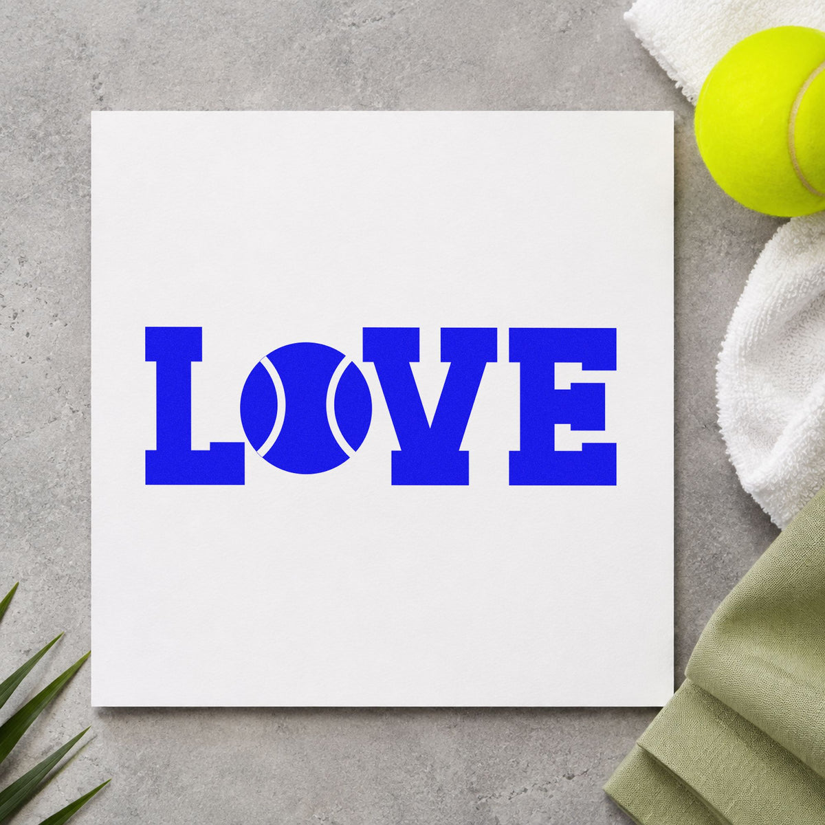 Love Tennis Ball Letter craft stamp imprinted in blue ink on paper, a design suited to framed club patio.