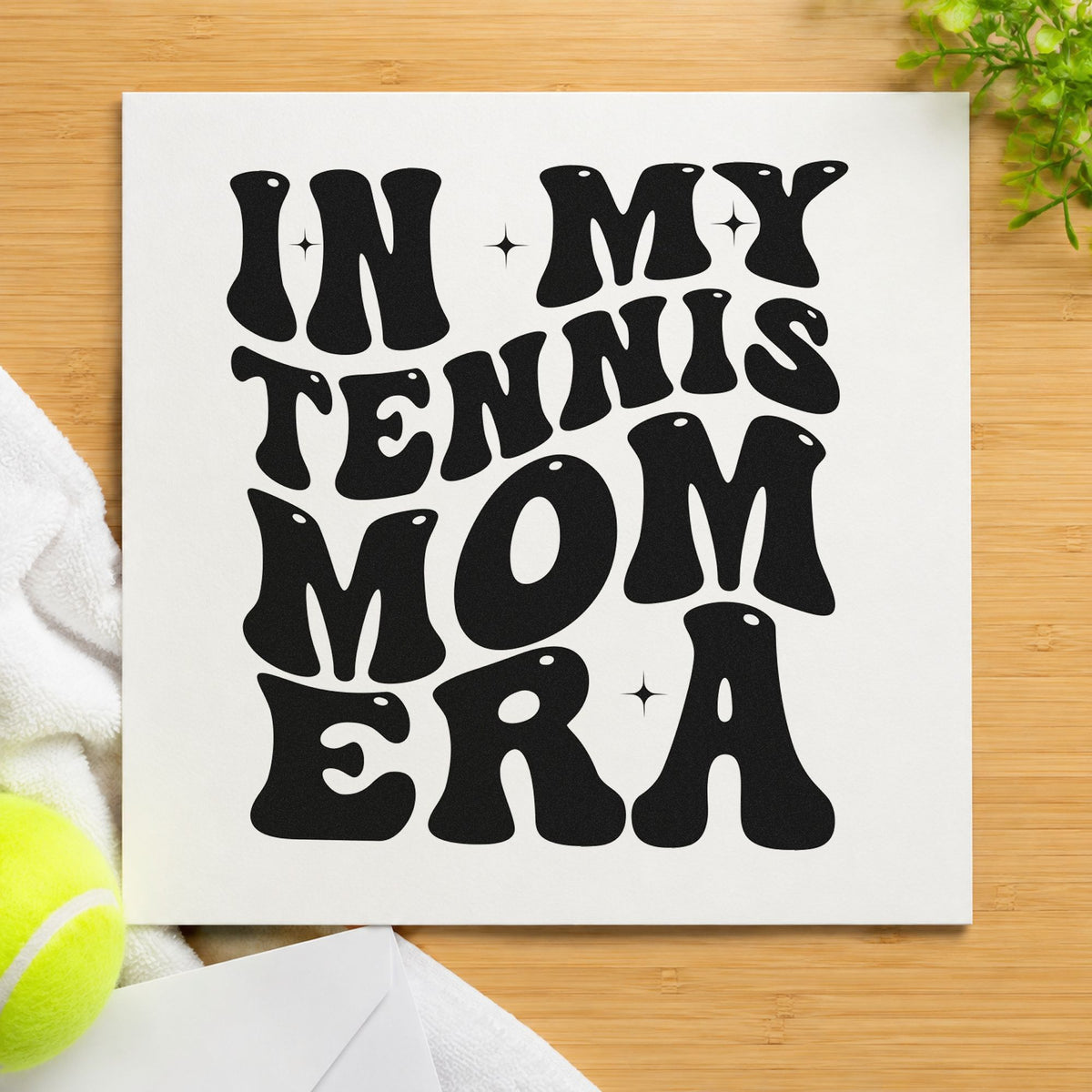 Tennis Mom Era Lettering craft stamp imprint in black ink on a handmade project, one idea being matching shirt tags.