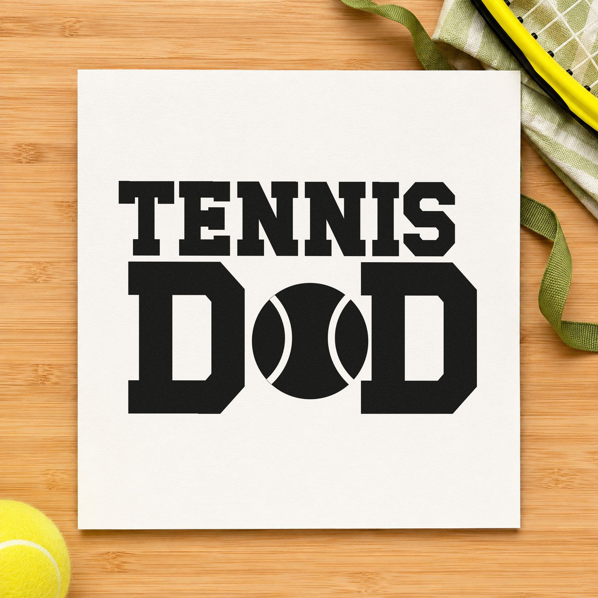 Tennis Ball Between D Letters craft stamp imprint in black ink on a handmade project, one idea being ball tube gift tags.