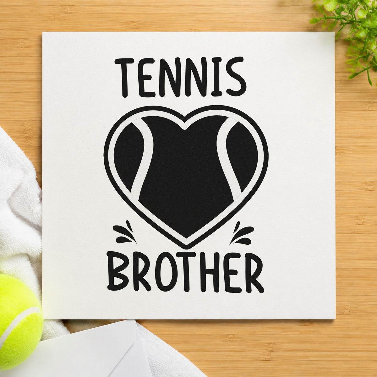Tennis Brother Heart Ball craft stamp imprint in black ink on a handmade project, one idea being ball tube gift tags.