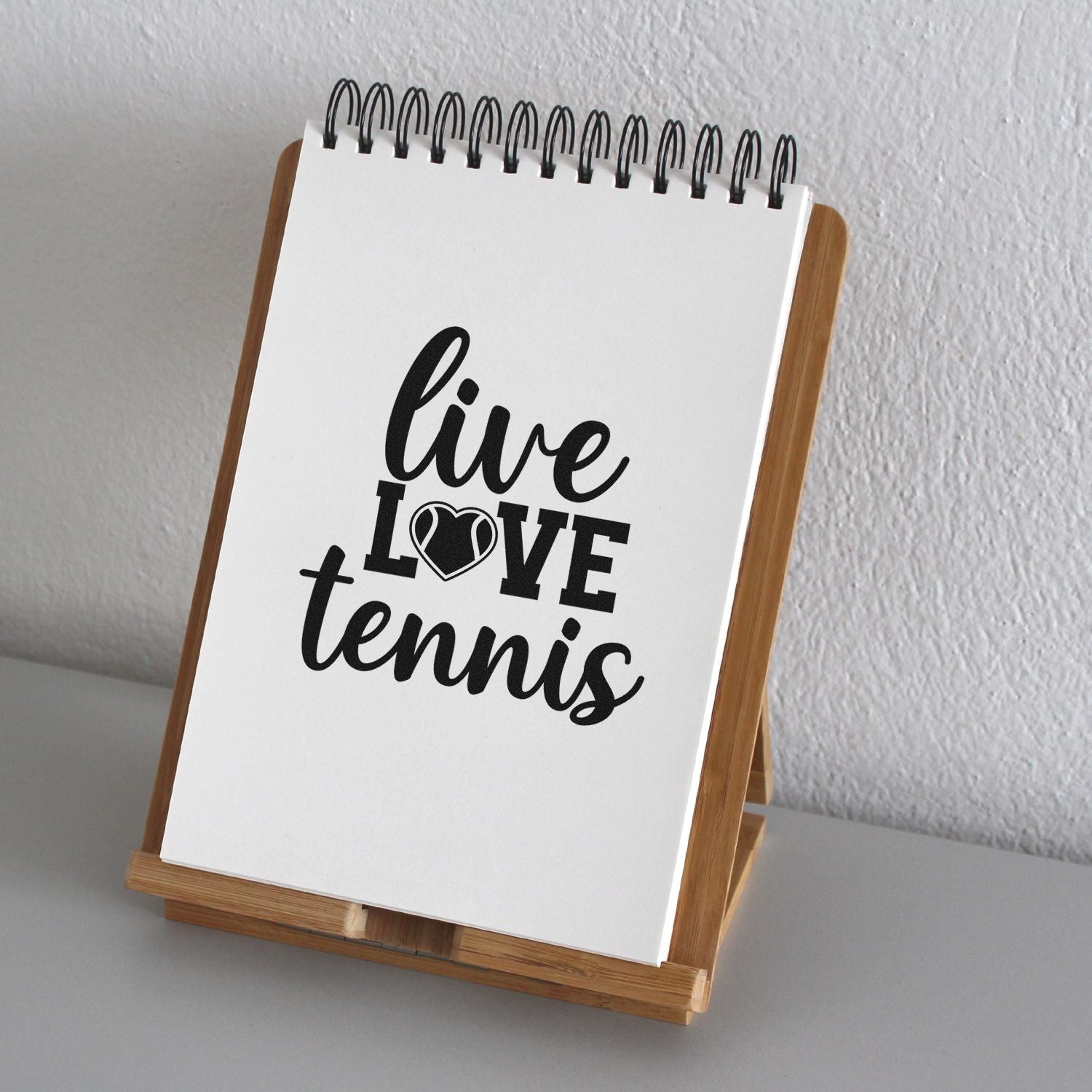 Live Love Tennis rubber stamp design on a spiral notepad stand for tennis-themed crafts, decor, and stationery.