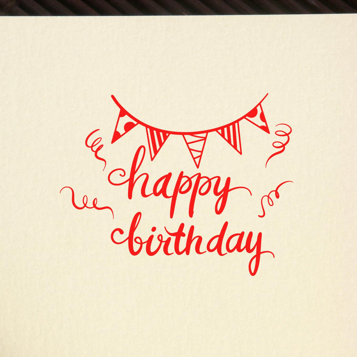 Birthday Bunting Streamer Script rubber stamp shown in red ink, stamped for projects such as garden party album page.
