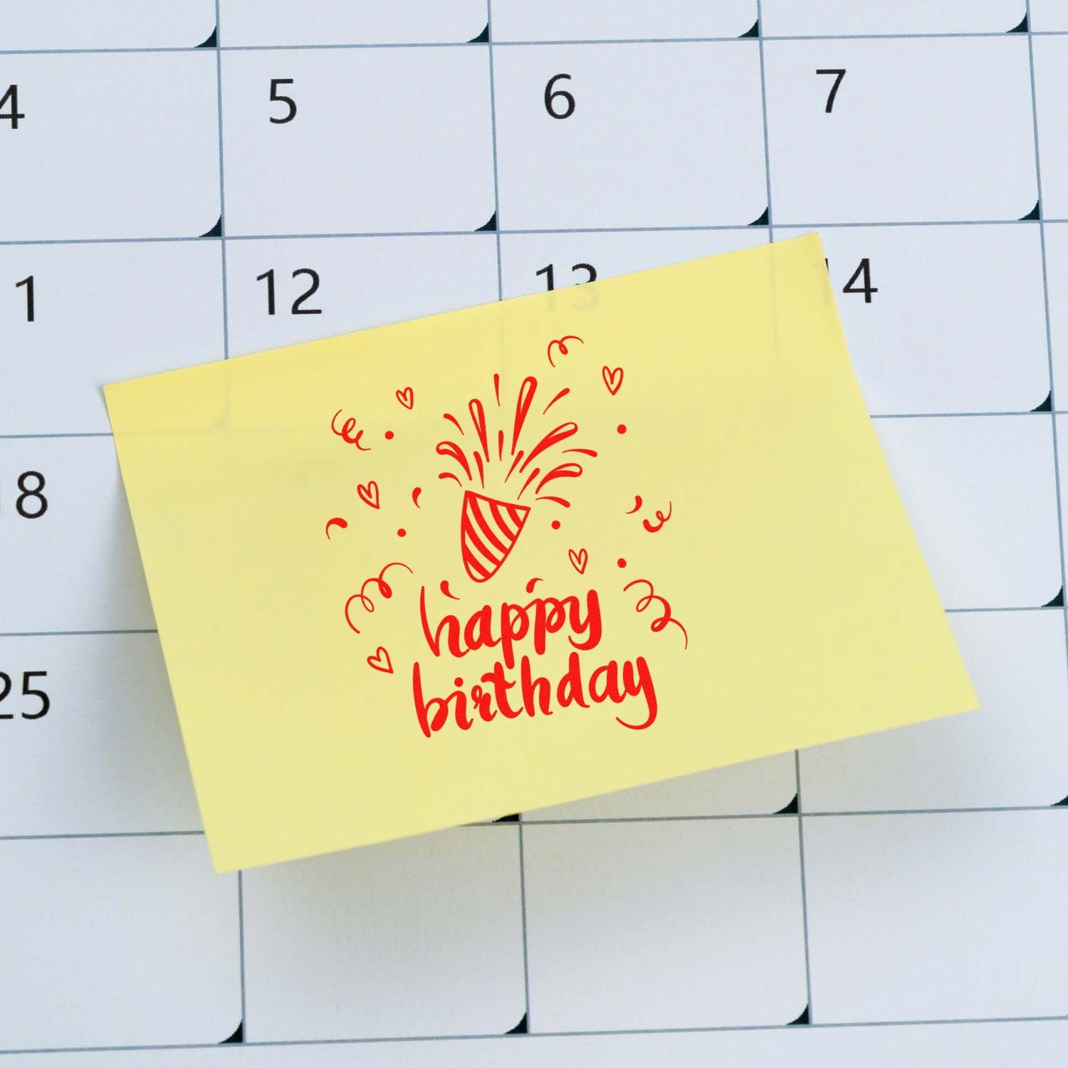 Happy birthday rubber stamp design on a sticky note over a calendar, ideal for birthday cards, planners, and gift packaging.