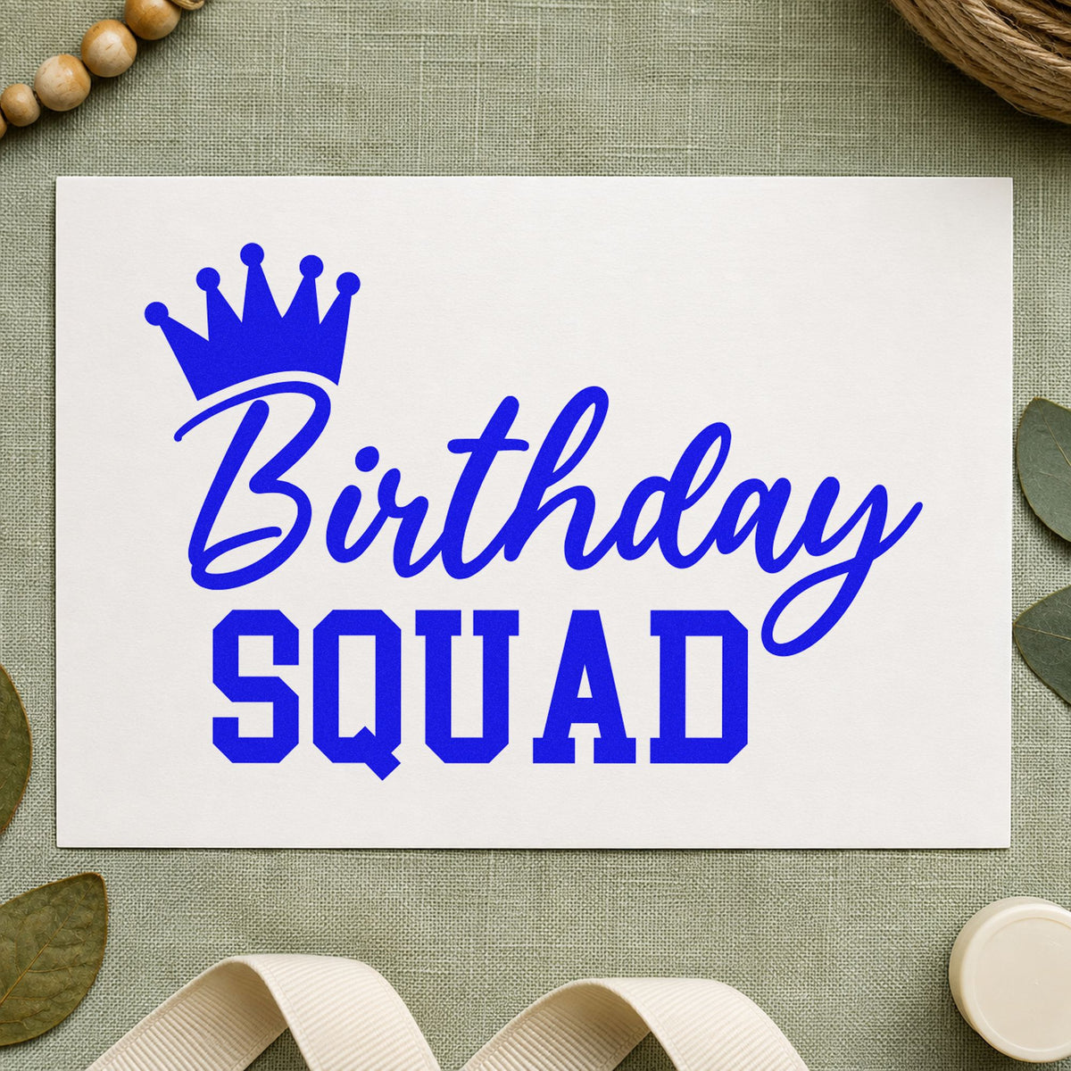 Birthday Squad Crown Script craft stamp imprinted in blue ink on paper, a design suited to framed rental hall.