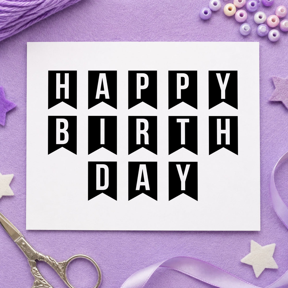 Happy Birthday Pennant Letters craft stamp imprint in black ink on a handmade project, one idea being outgoing item tags.