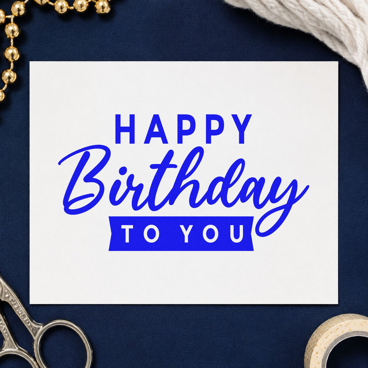 Happy Birthday To You craft stamp imprinted in blue ink on paper, a design suited to framed front porch.