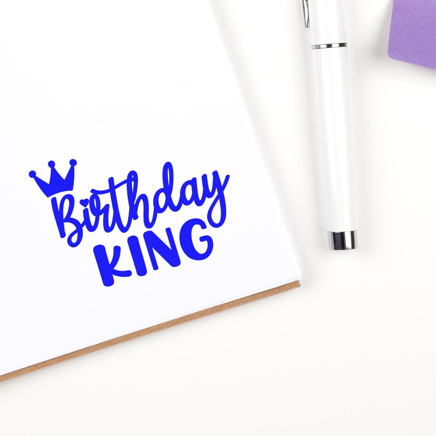Birthday King rubber stamp design in blue on white card, perfect for custom birthday cards and party invitations.