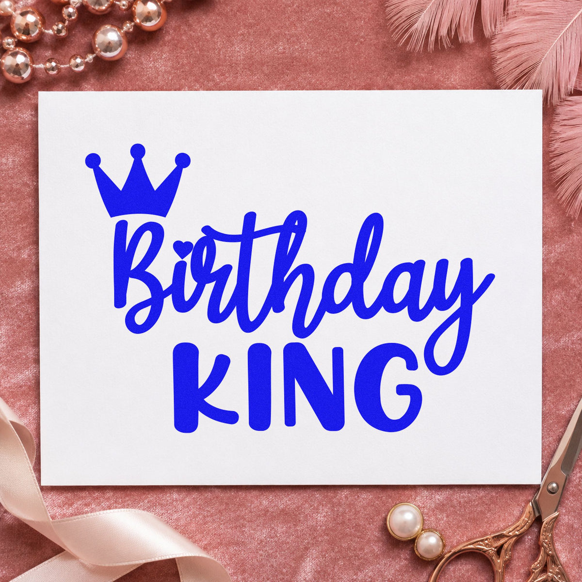 Birthday King Tilted Crown craft stamp imprinted in blue ink on paper, a design suited to framed bedroom wall.