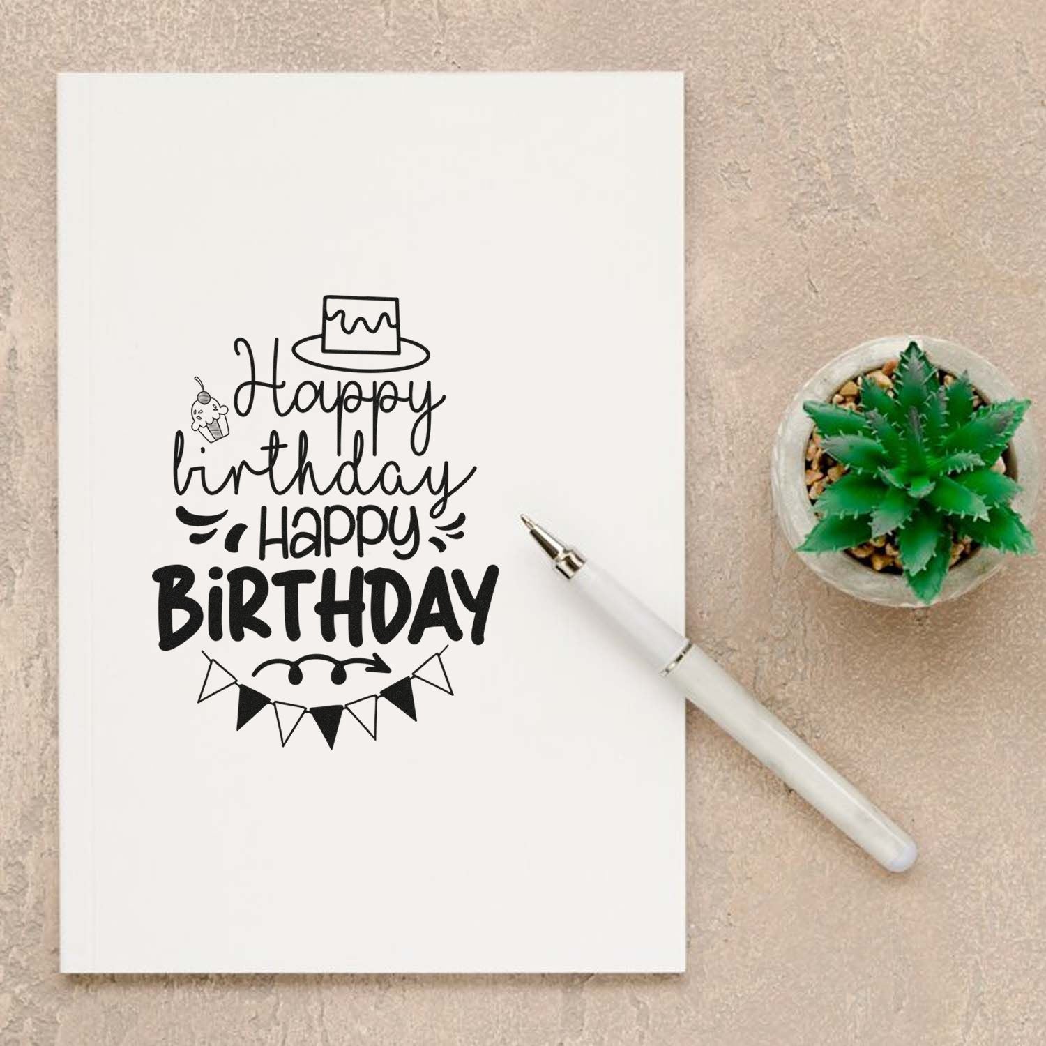 Happy Birthday rubber stamp design on notebook, ideal for handmade birthday cards and DIY crafting.