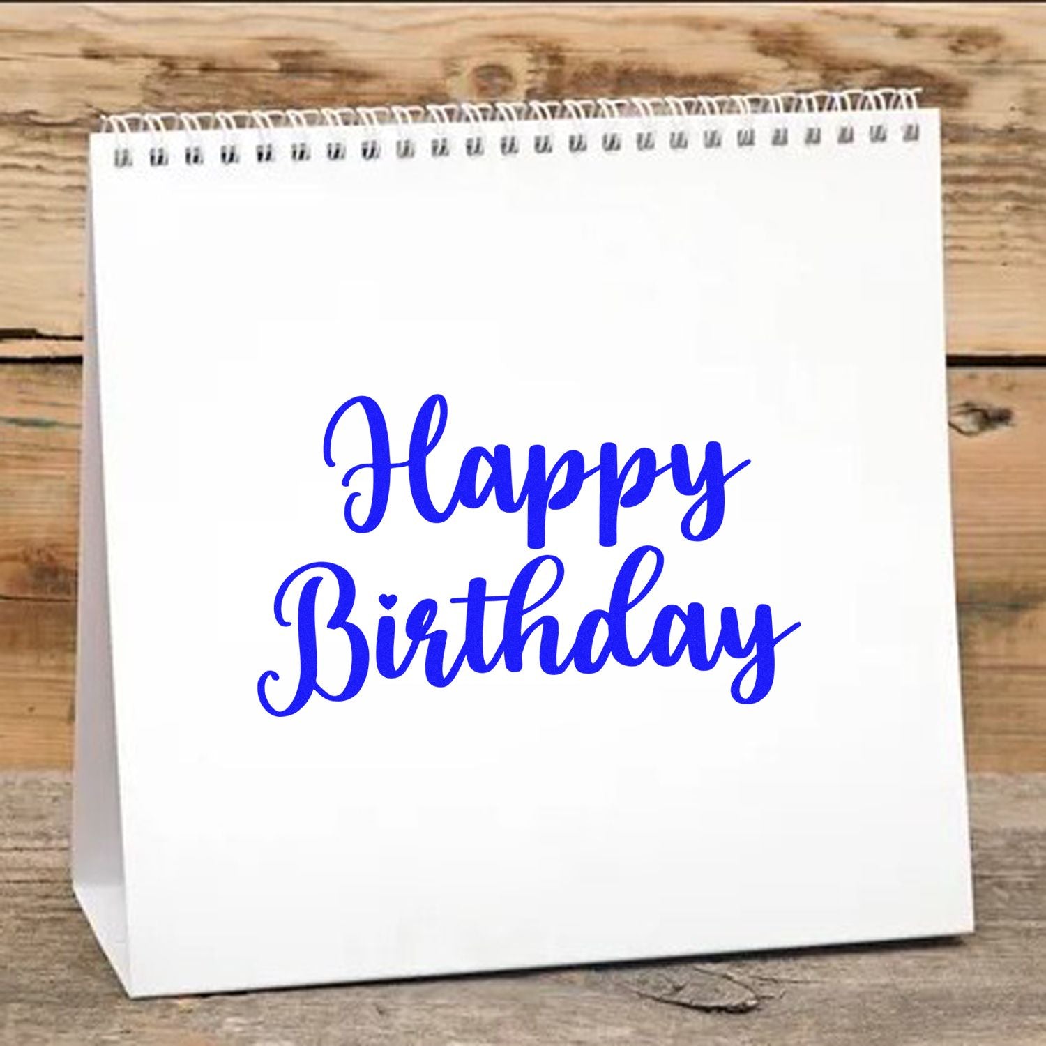 Happy Birthday rubber stamp design in blue script on a white gift bag for birthday party favors