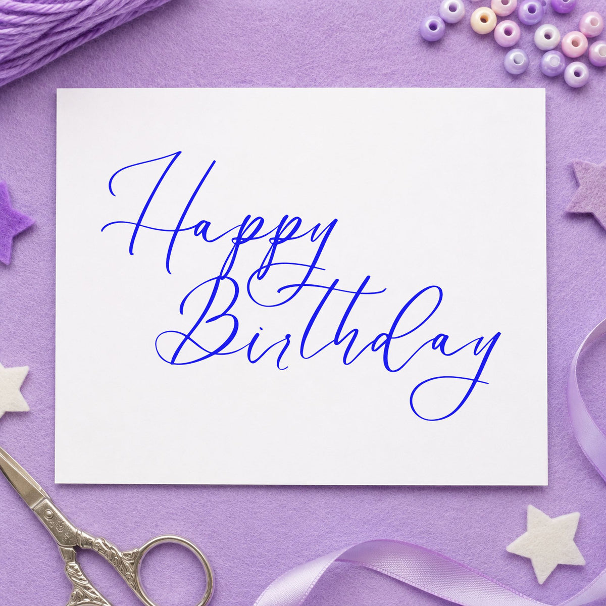 Elegant Happy Birthday Calligraphy craft stamp in blue ink on cardstock, an easy option for desk blotter printing.