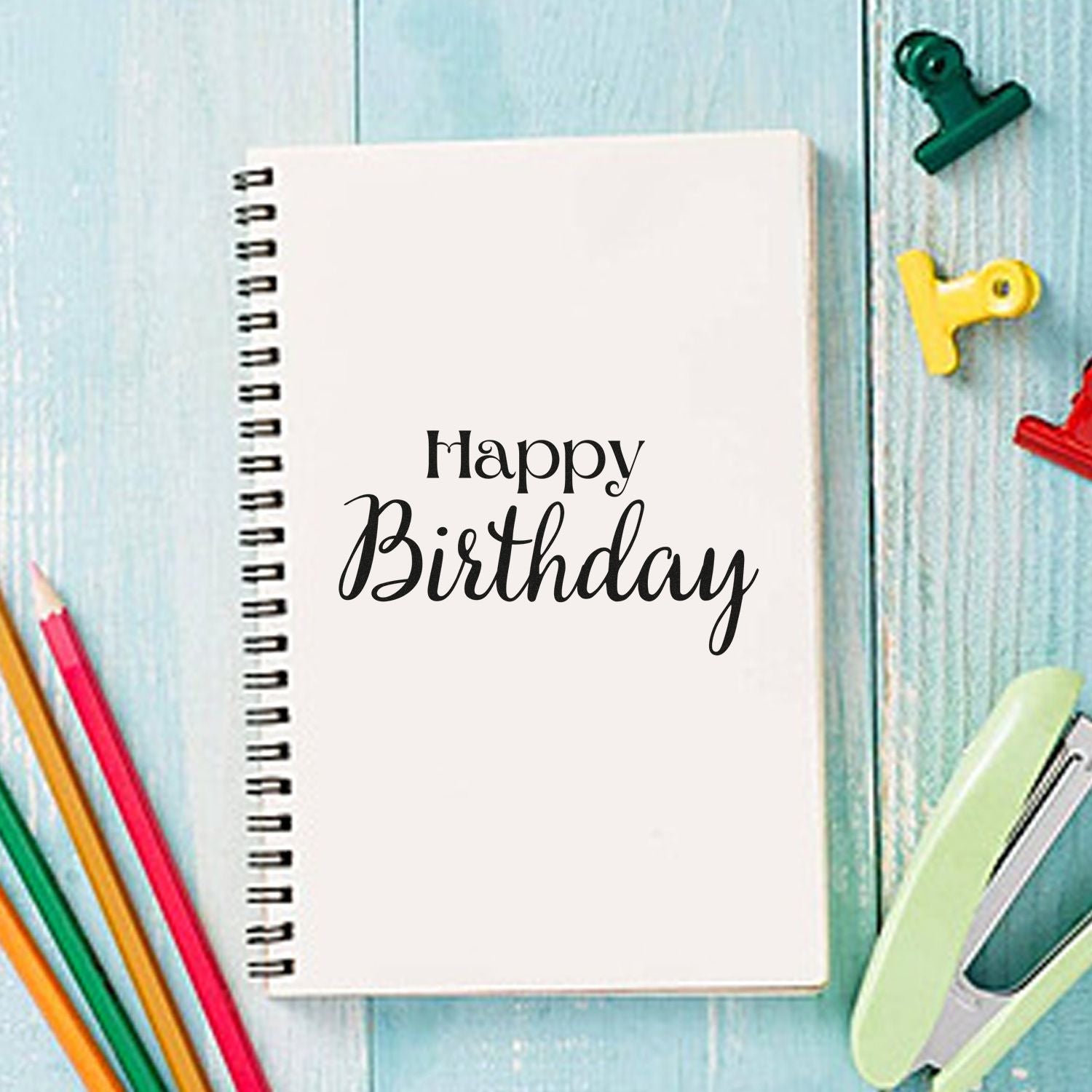 Happy Birthday rubber stamp design for cards, scrapbooking, and custom stationery on a notebook.