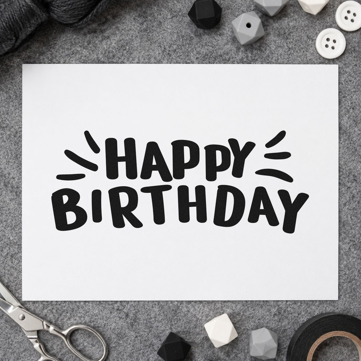 Happy Birthday Radiating Strokes craft stamp imprint in black ink on a handmade project, one idea being grip sock gift tags.