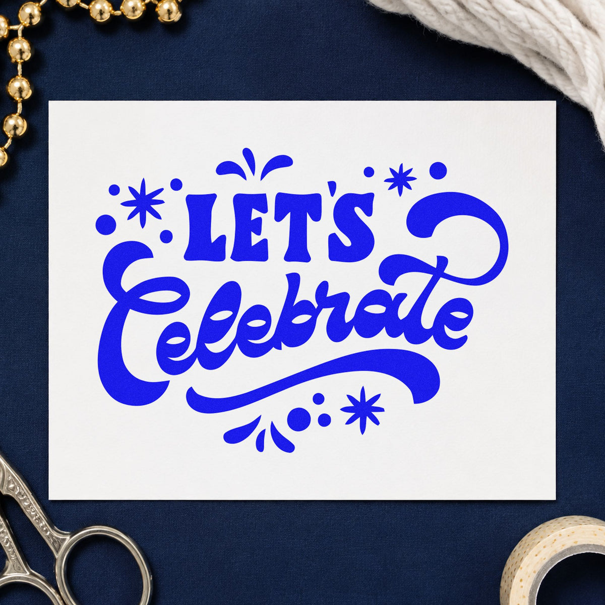 Let's Celebrate Script craft stamp imprinted in blue ink on paper, a design suited to framed hall entry.