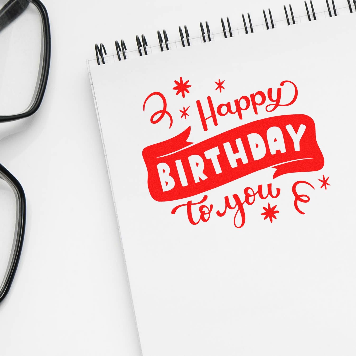 Happy Birthday rubber stamp design on notebook paper, ideal for birthday card crafting and custom stamp projects.