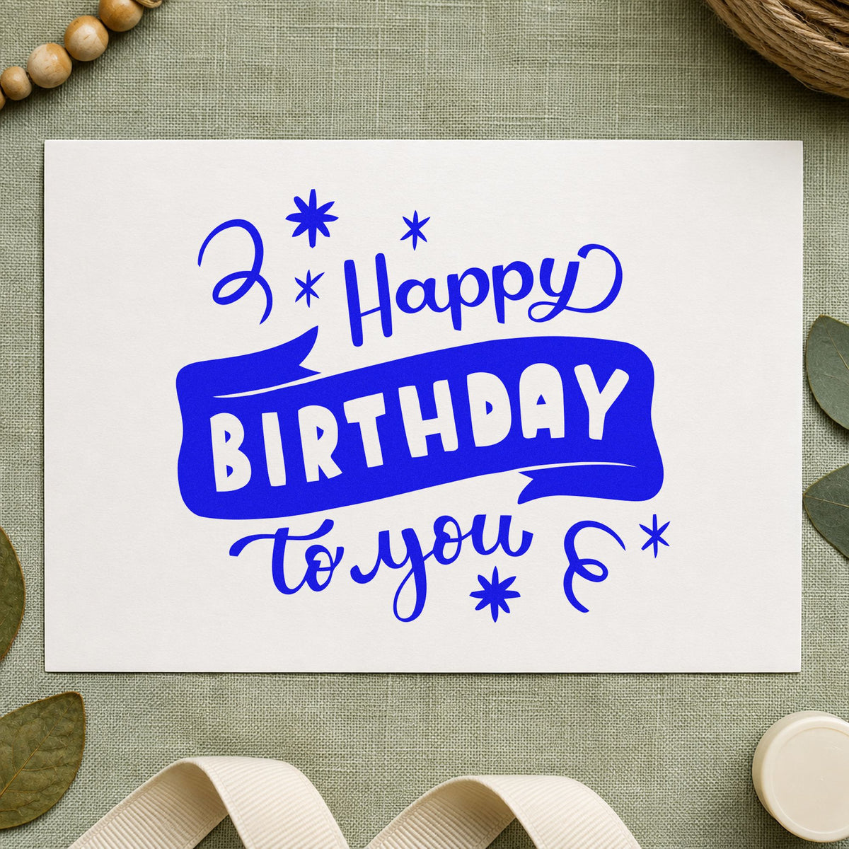 Happy Birthday To You craft stamp imprinted in blue ink on paper, a design suited to framed class room.