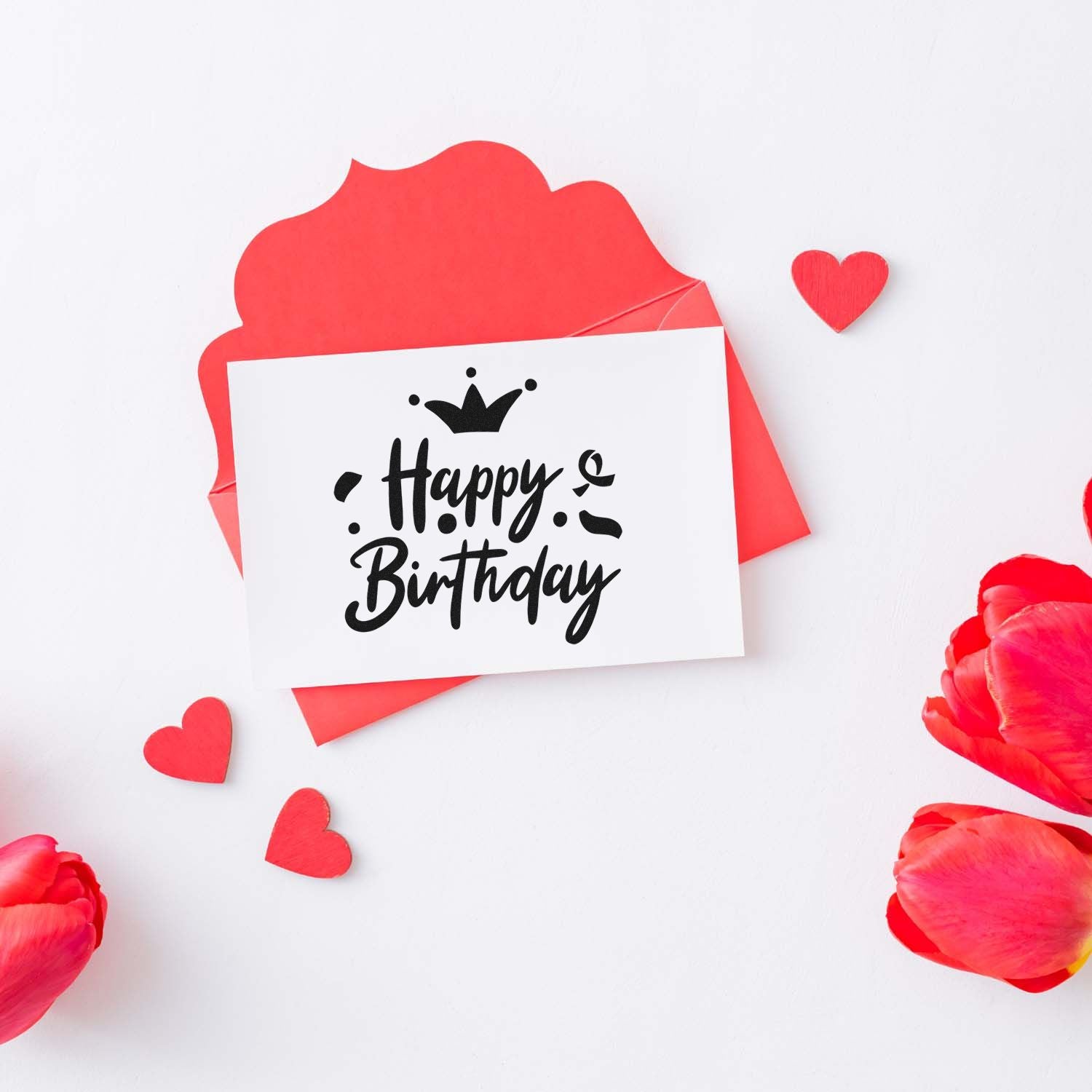 Happy Birthday rubber stamp design with crown, hearts, and floral accents on a red card and envelope