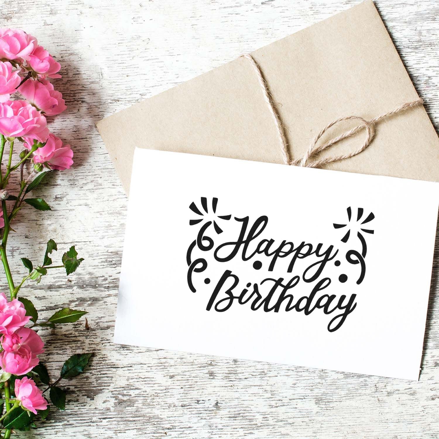Happy Birthday rubber stamp design on a handmade card with twine-wrapped envelope and pink flowers