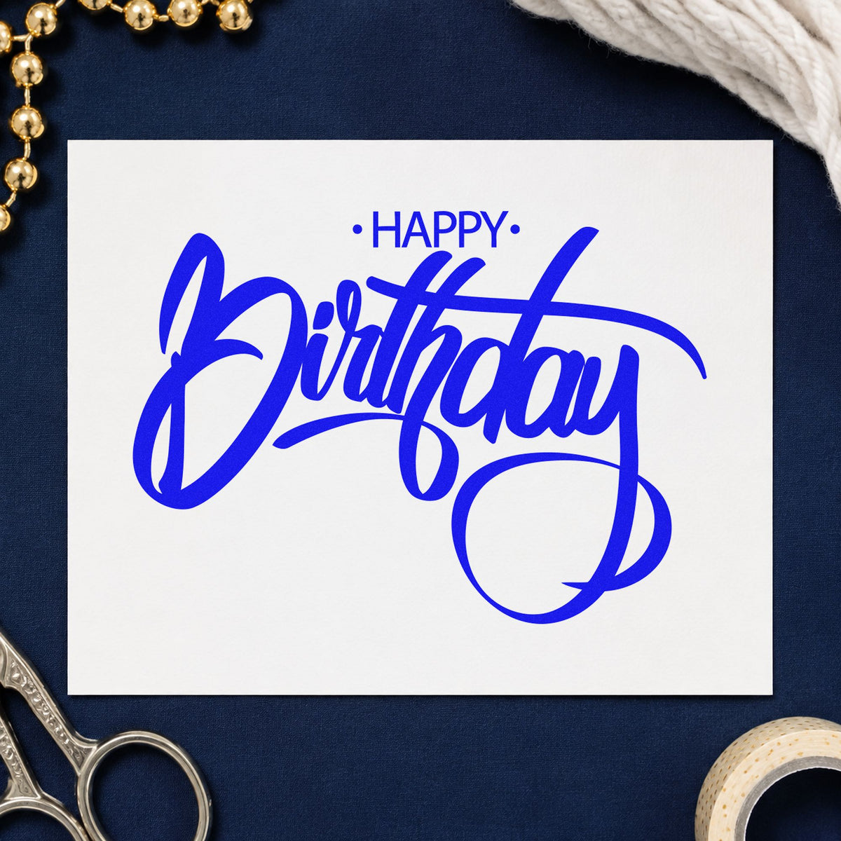 Birthday Large Loop Script craft stamp imprinted in blue ink on paper, a design suited to framed paint shop.