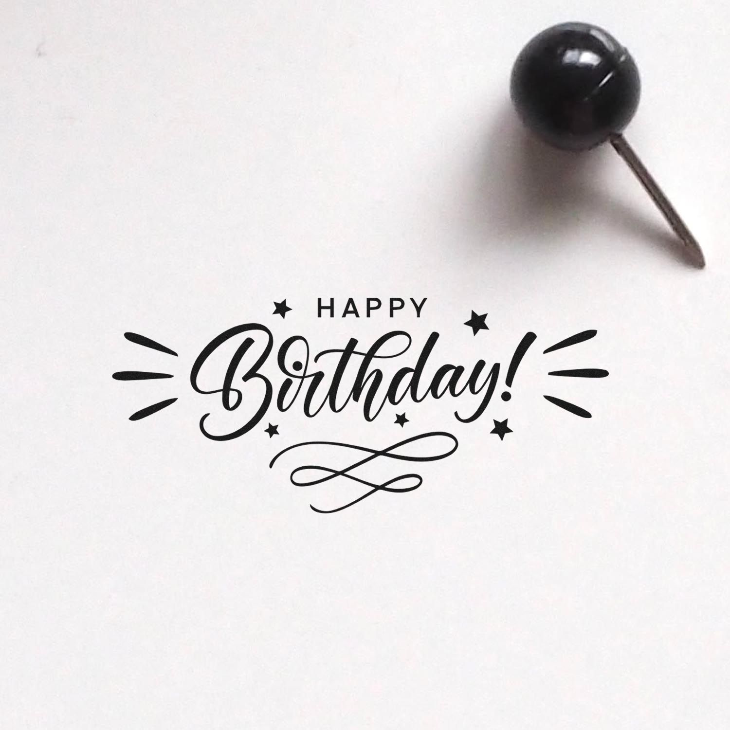Happy Birthday rubber stamp impression with stars and swirls for birthday cards, invitations, and custom packaging.
