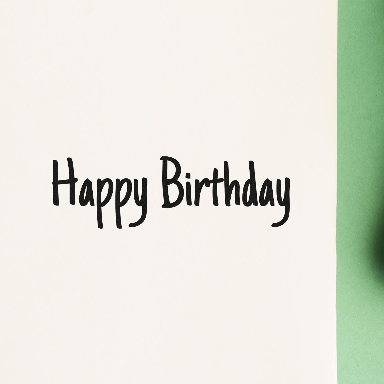 Happy Birthday script rubber stamp on white cardstock, perfect for handmade birthday cards and party invitations.