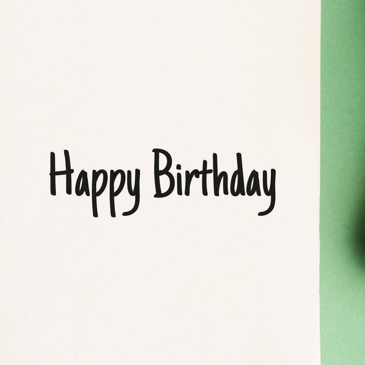 Premium Wooden Happy Birthday Narrow Handwriting Lettering Stamp - Vintage Pro imprint stamped in black ink. Happy Birthday appears in one line of narrow uneven hand lettering.