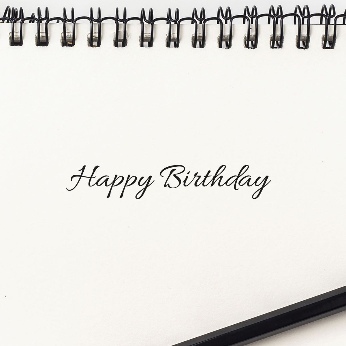 Happy Birthday Delicate Connected Script Premium Wooden Stamp - Vintage Pro imprint stamped in black ink. Happy Birthday appears in one line of small delicate connected script.
