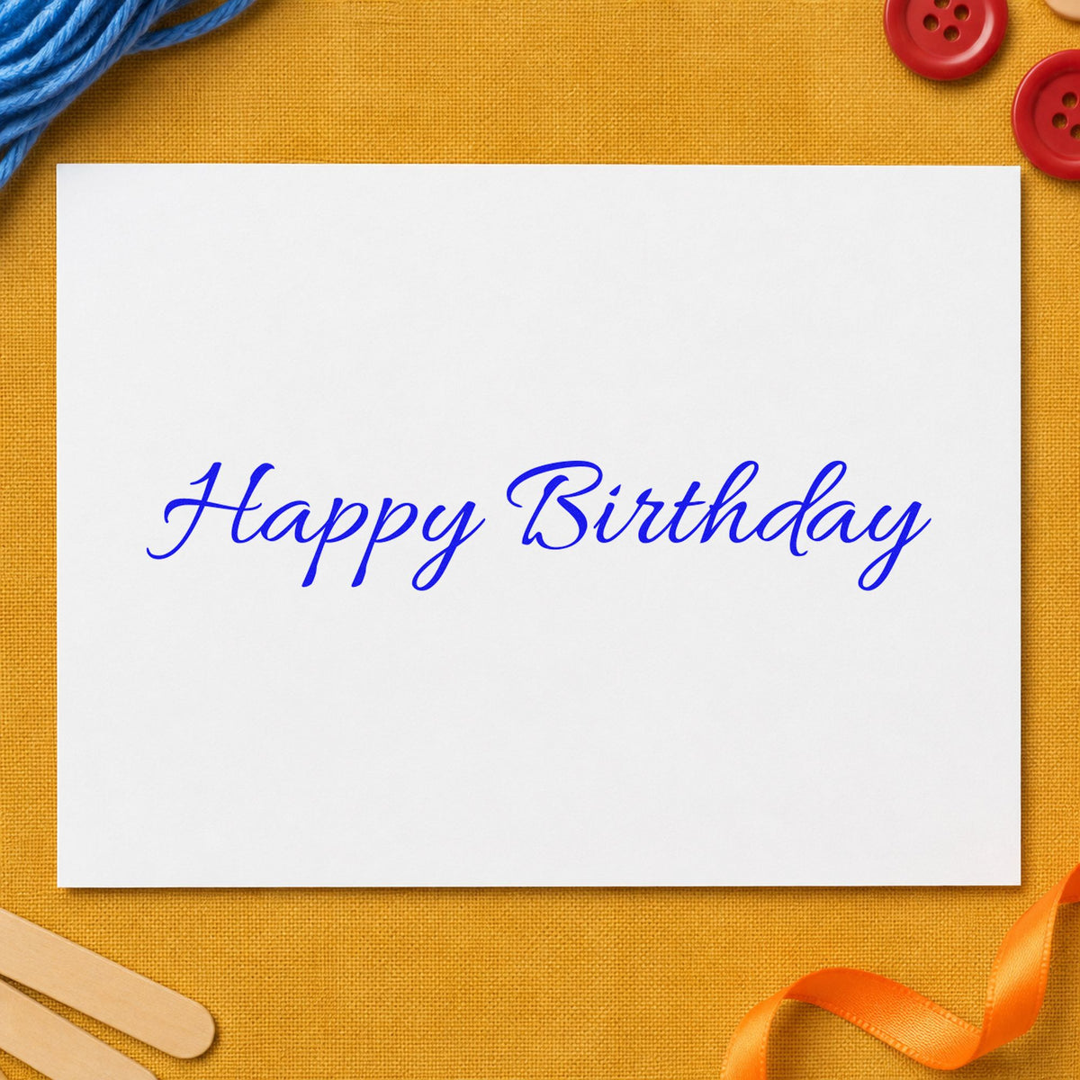 Happy Birthday Fine Script craft stamp in blue ink on cardstock, an easy option for tray cloth printing.