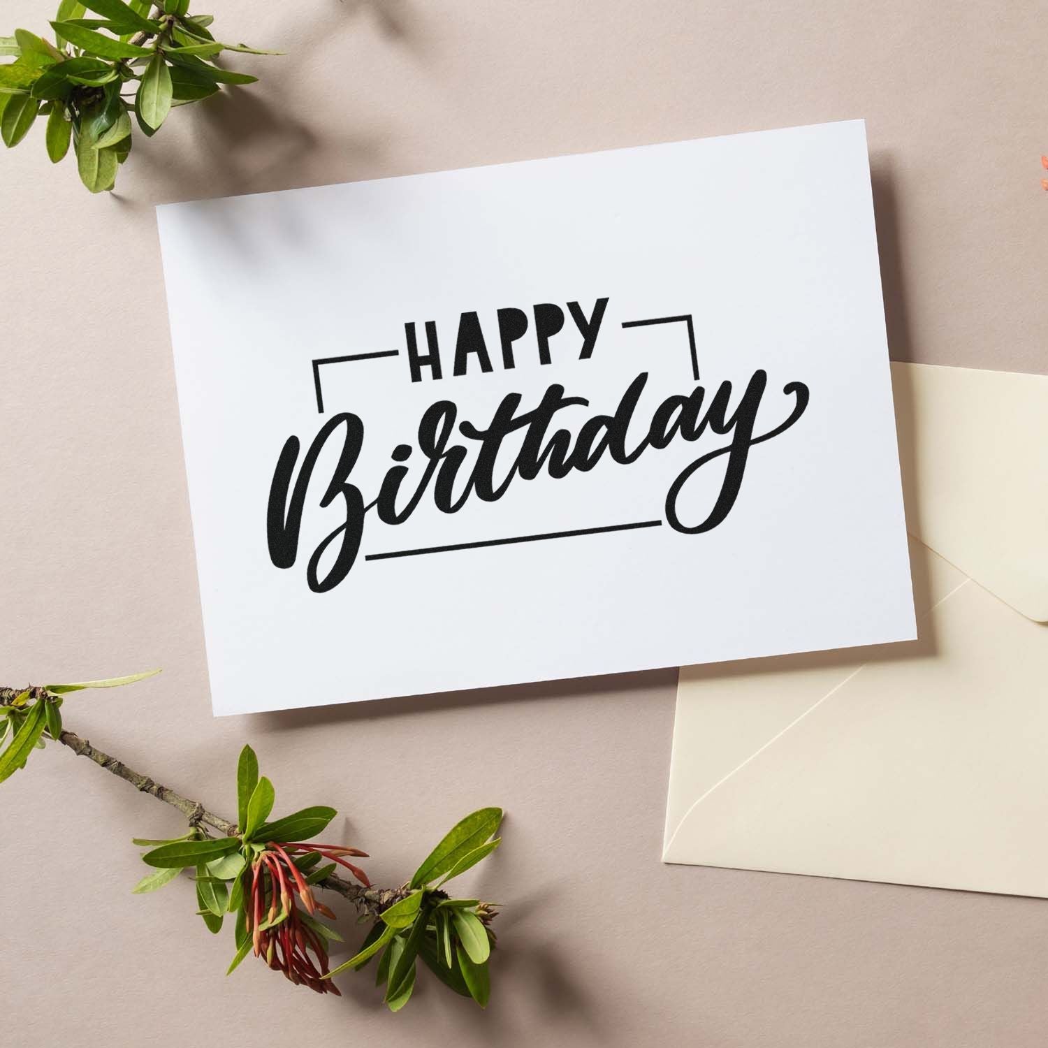 Happy Birthday rubber stamp for handmade birthday cards, displayed on white paper with envelope and greenery.