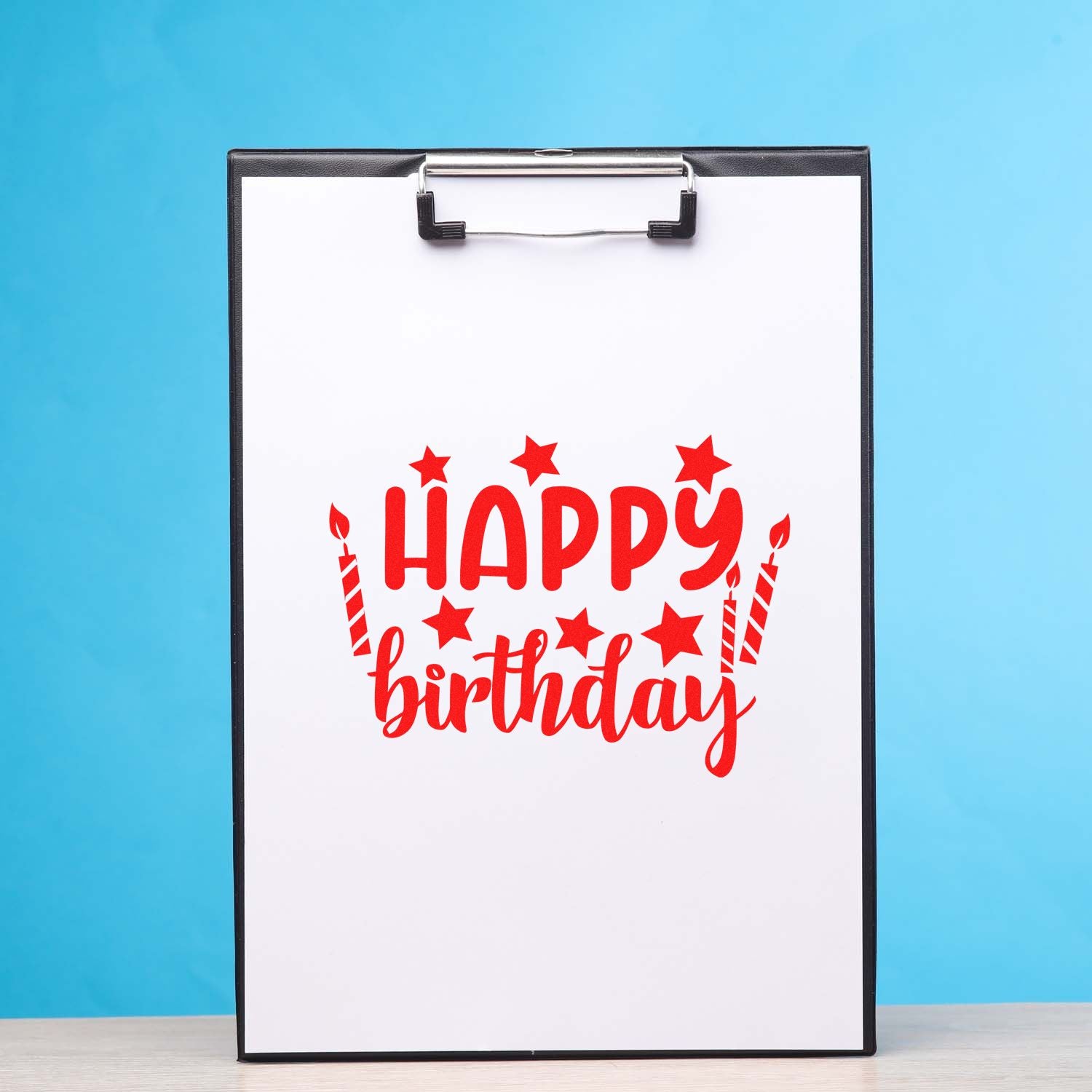 Happy birthday rubber stamp design with candles and stars on clipboard, perfect for birthday cards and party invitations.