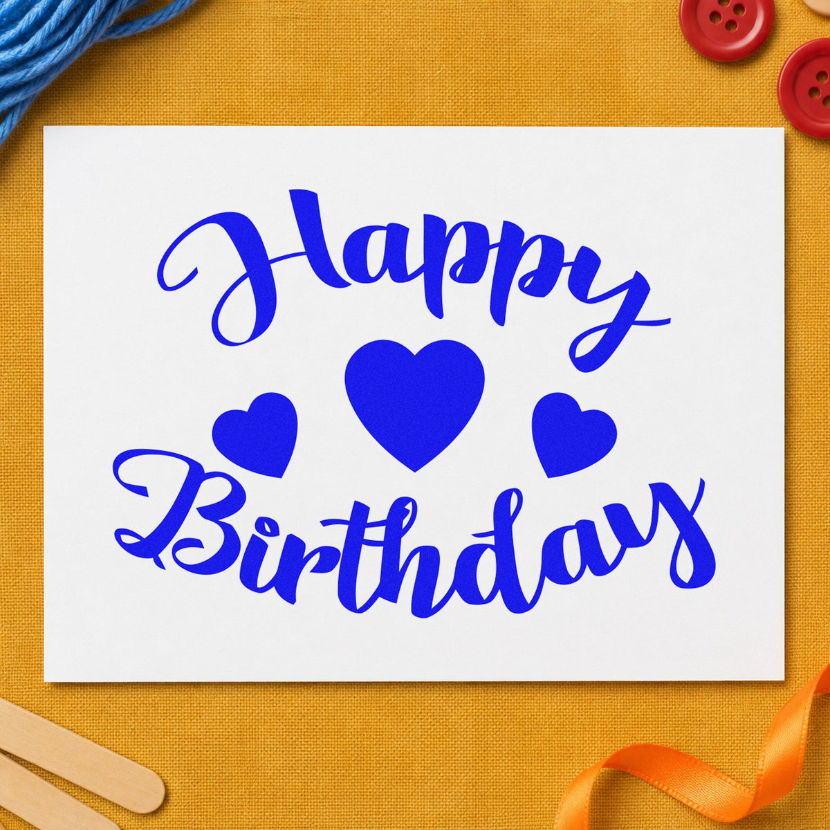 Happy Birthday Three Hearts craft stamp in blue ink on cardstock, an easy option for backdrop cloth printing.