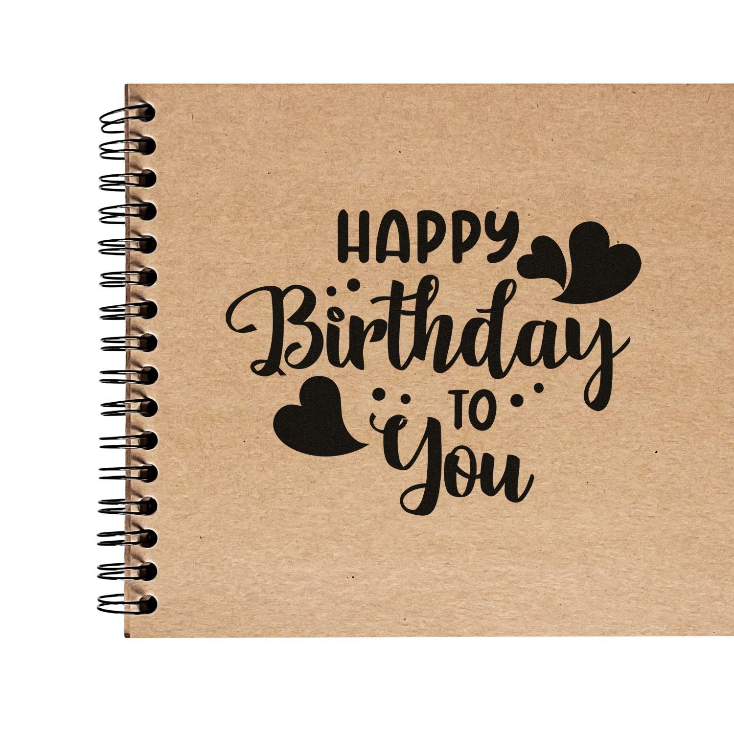 Happy Birthday to You rubber stamp design with heart accents on a kraft notebook cover.