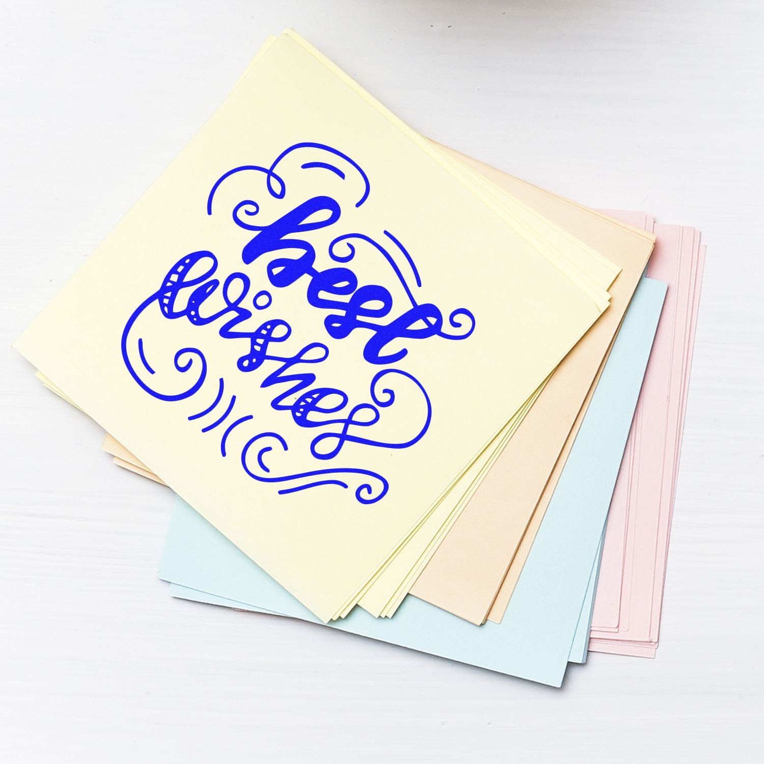 Custom rubber stamp design reading Be Yourself on pastel stationery paper stack.