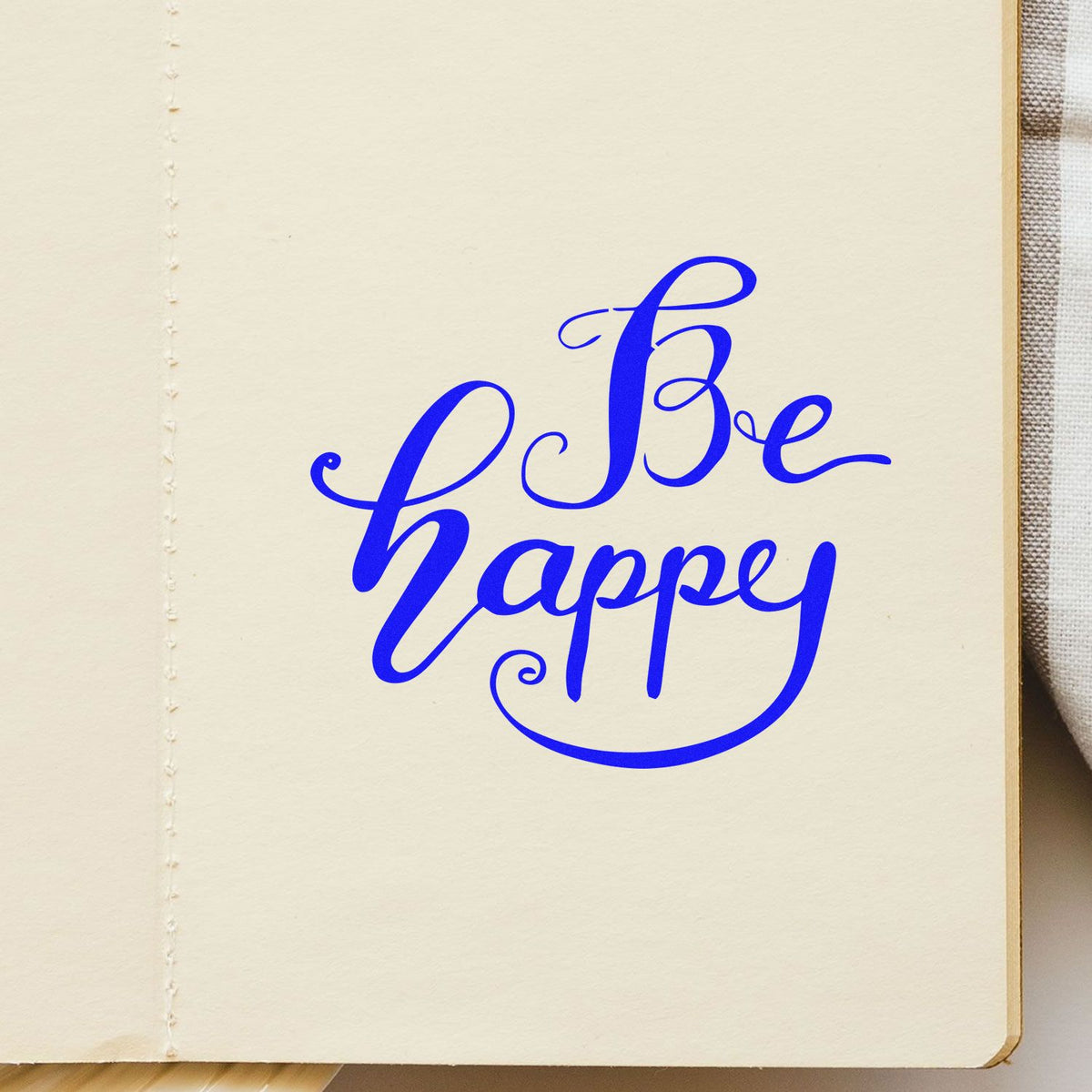 Be Happy Flowing Script rubber stamp shown in blue ink, stamped for projects such as slow day album page.