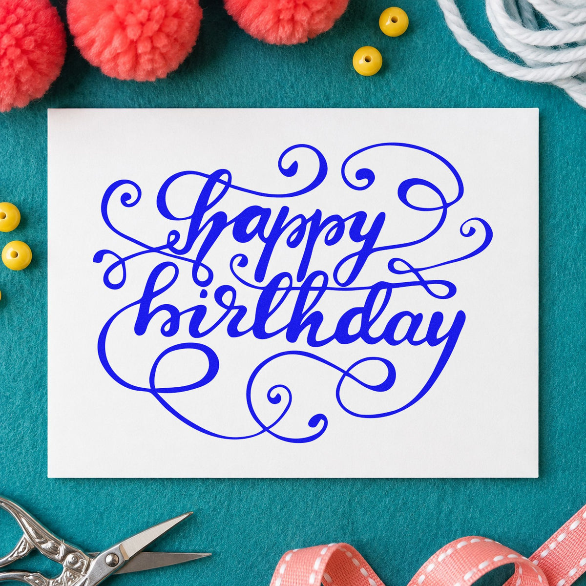 Happy Birthday Ornate Loops craft stamp in blue ink on cardstock, an easy option for table cloth printing.