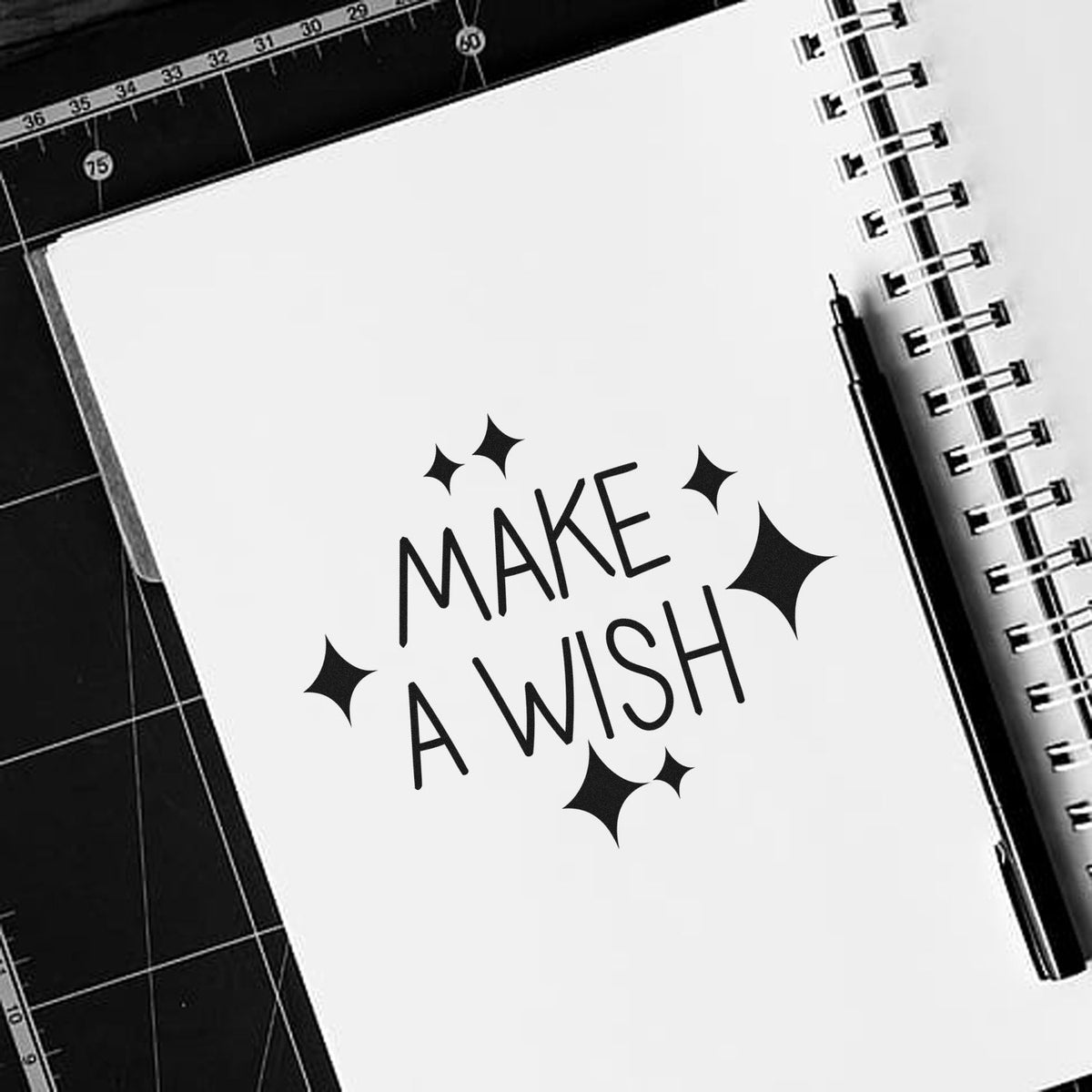 Make A Wish Sparkles Premium Wooden Stamp - Vintage Pro imprint stamped in black ink. MAKE A WISH appears in thin hand-drawn capitals surrounded by diamond-shaped sparkles.