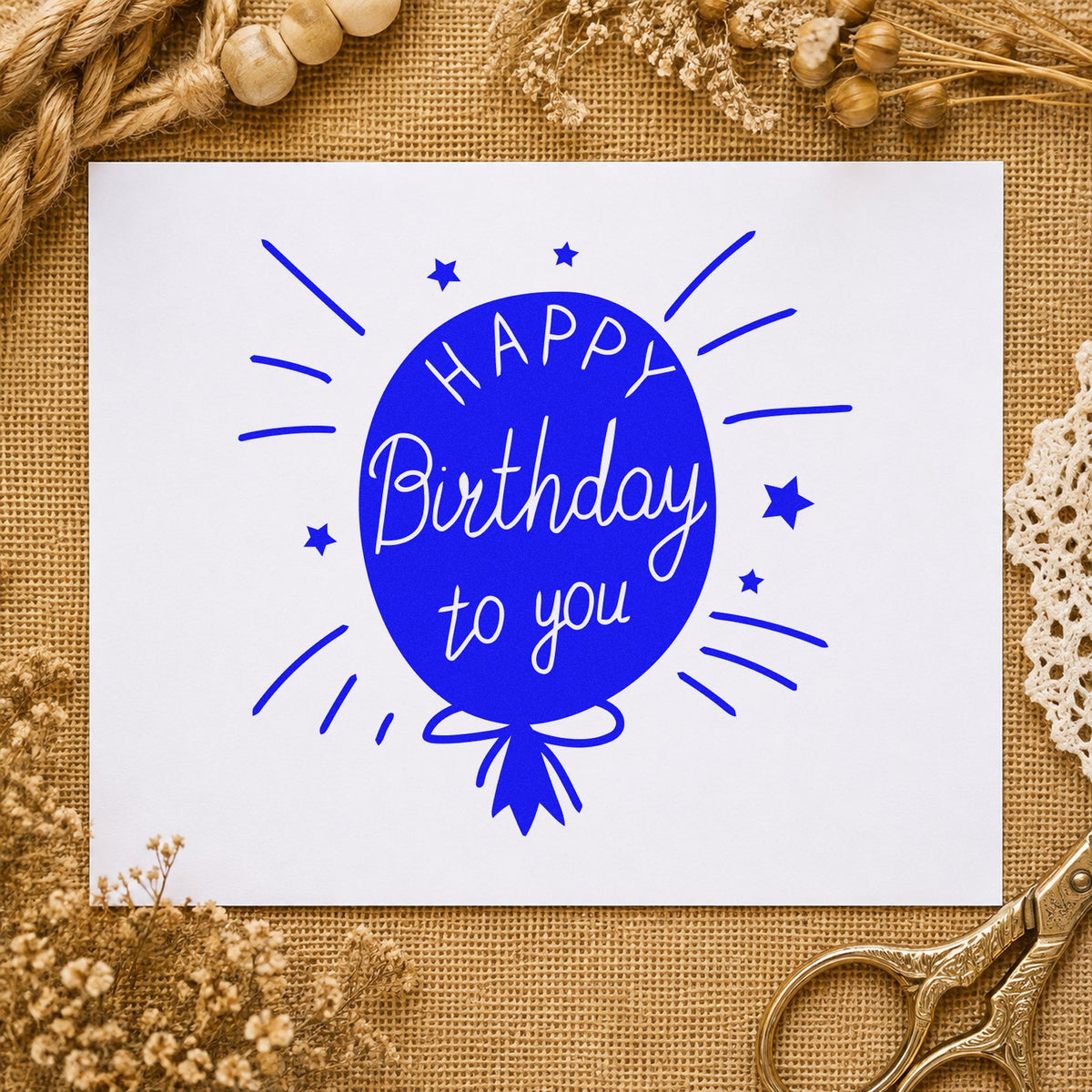 Birthday To You Balloon craft stamp in blue ink on cardstock, an easy option for window cloth printing.