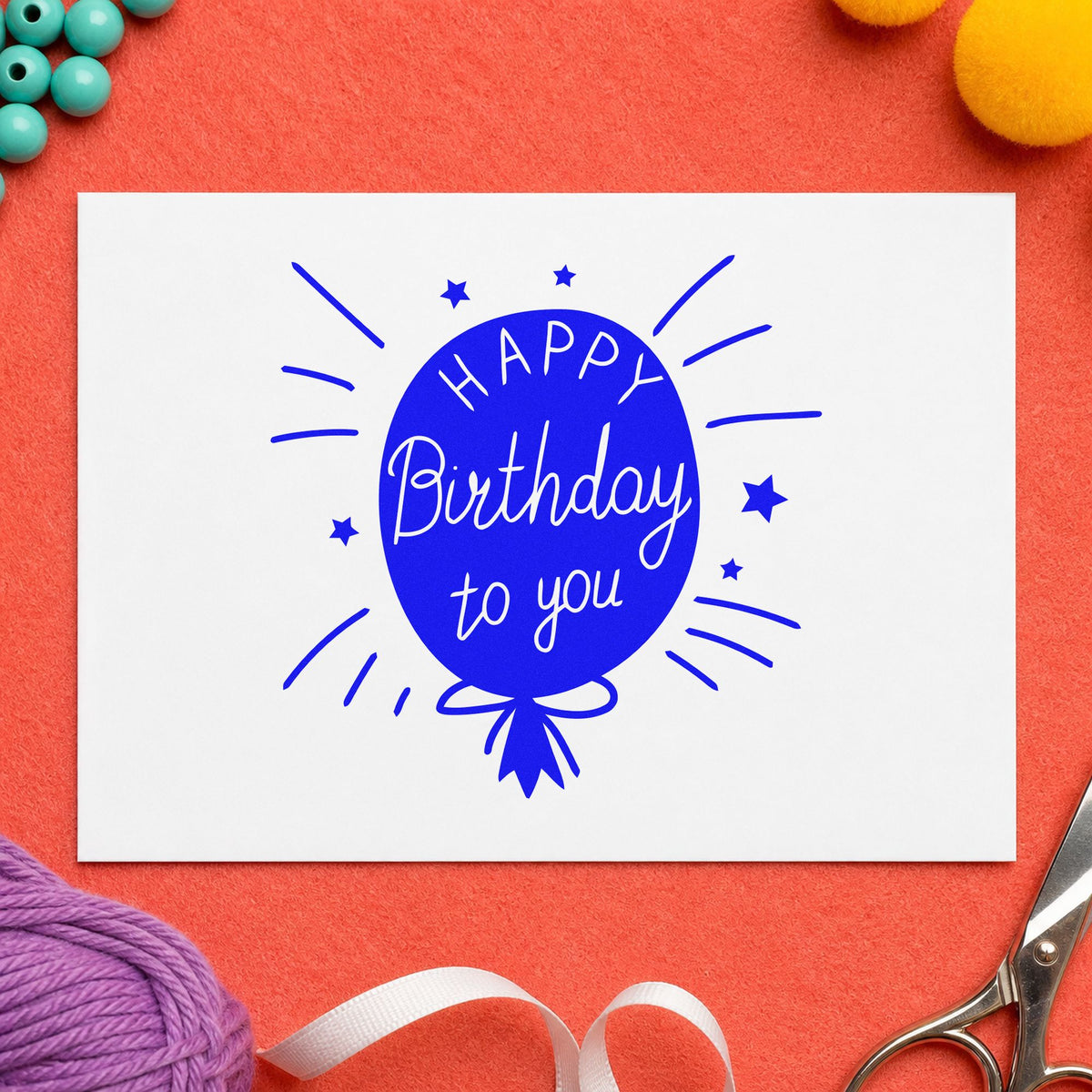 Birthday To You Balloon craft stamp imprinted in blue ink on paper, a design suited to framed front window.