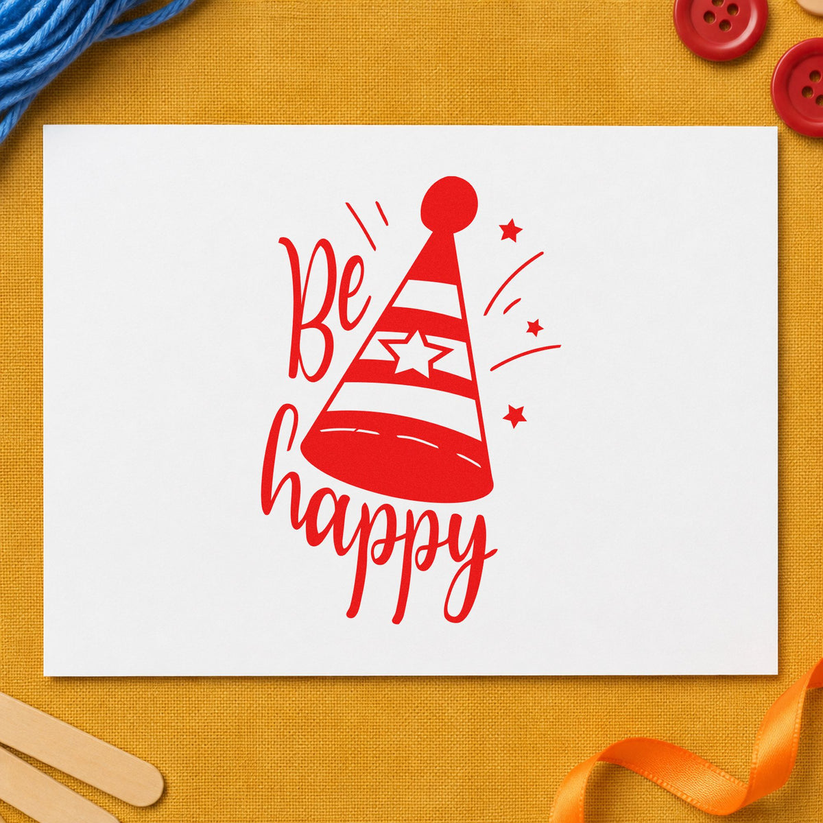 Be Happy Party Hat rubber stamp shown in red ink, stamped for projects such as bin post labels.