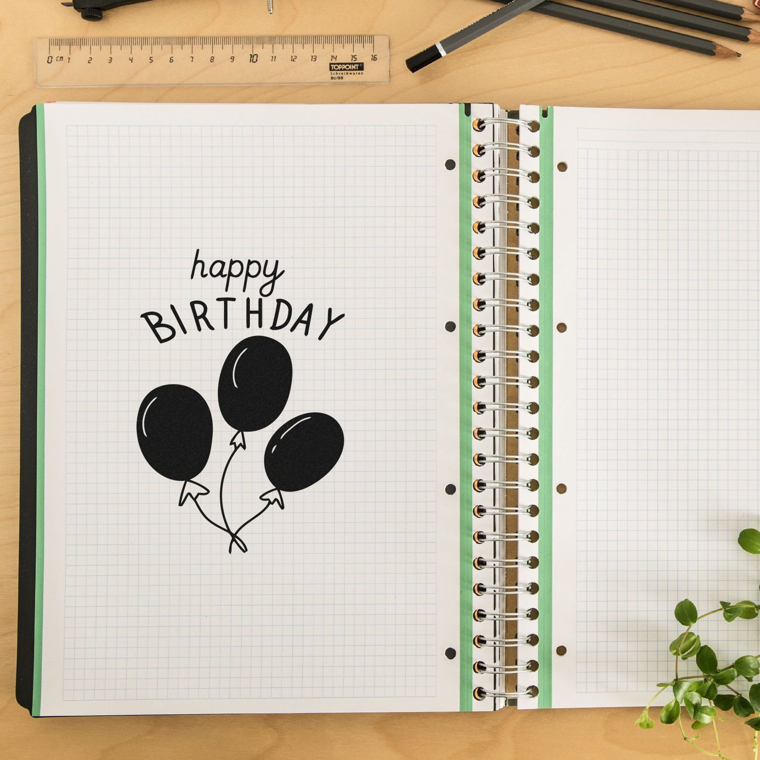 Happy birthday rubber stamp design with black balloons on notebook paper