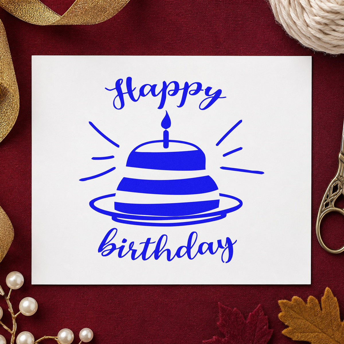 Happy Birthday Cake Rays craft stamp in blue ink on cardstock, an easy option for high chair printing.